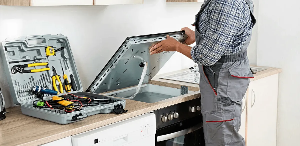 Handyman repairing a cooktop and checking wiring connections in Providence, RI