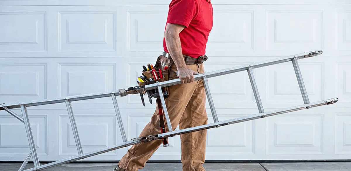 Garage door repair technician arriving with tools and ladder in Providence, RI