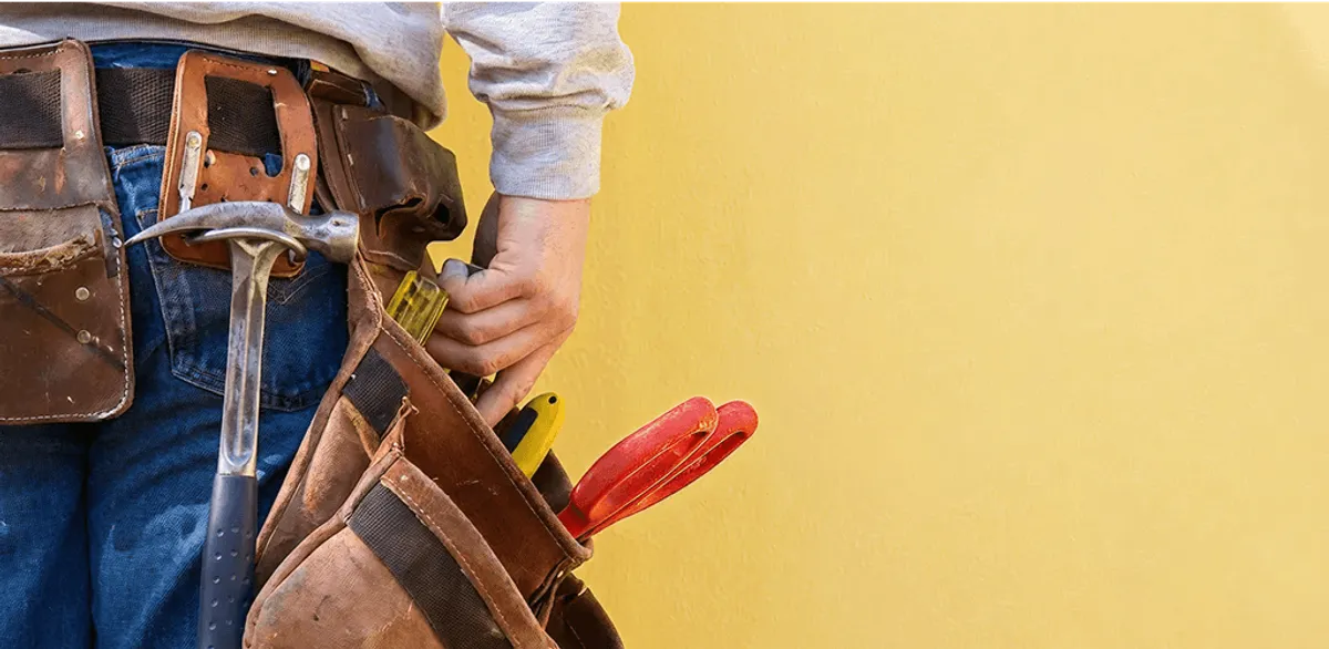Handyman with tool belt ready for home repairs and maintenance in Providence, RI